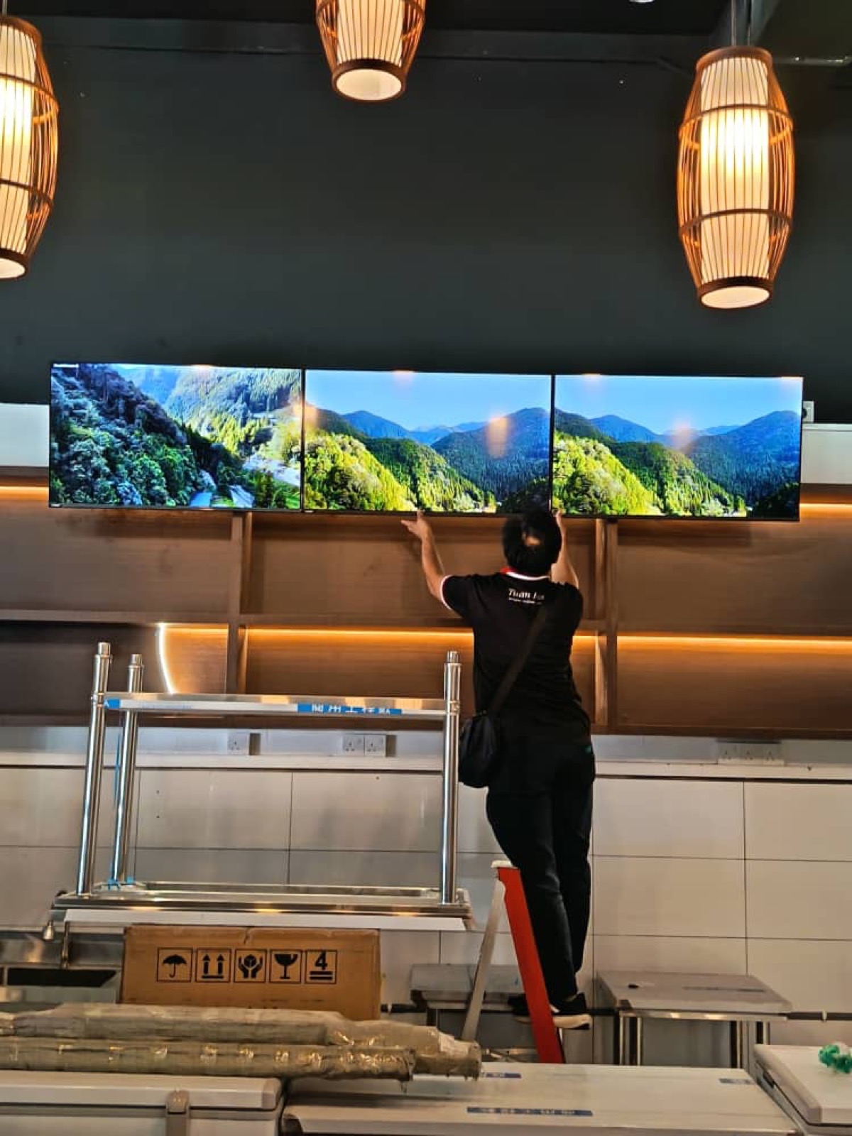 Our team mounting a multi-screen display in-store.